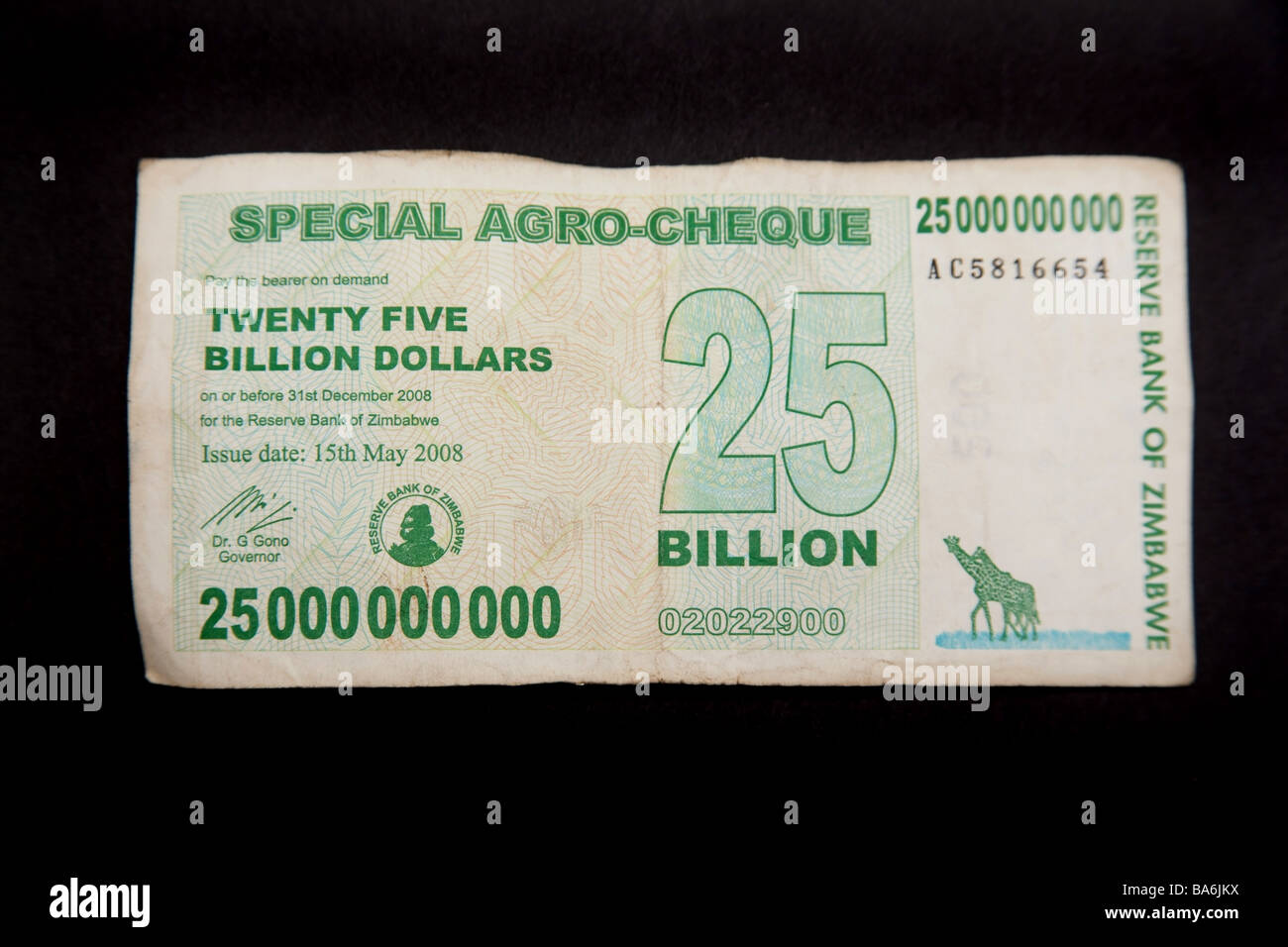 Zimbabwean 25 billion dollar note on a black studio background Stock Photo