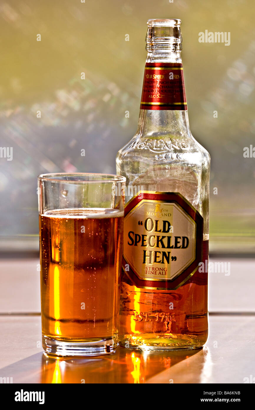 Best bitter Old Speckled Hen in bottle and glass backlit and sparkling in  sun Stock Photo - Alamy