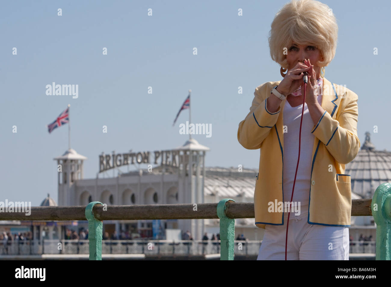 Drag queen Patsy Cabaret singing near Palace Pier Brighton, Easter Bank