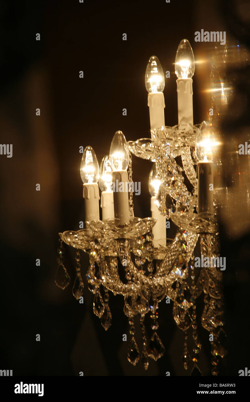 elegant glass chandelier light fitting in dark room Stock Photo Alamy