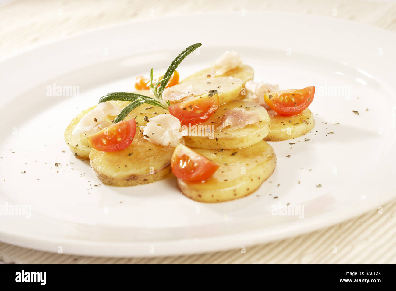 Plates Bratkartoffeln hams prepared cherry-tomatoes rosemary nutrition table Essteller food knows potato-court lunches Stock Photo