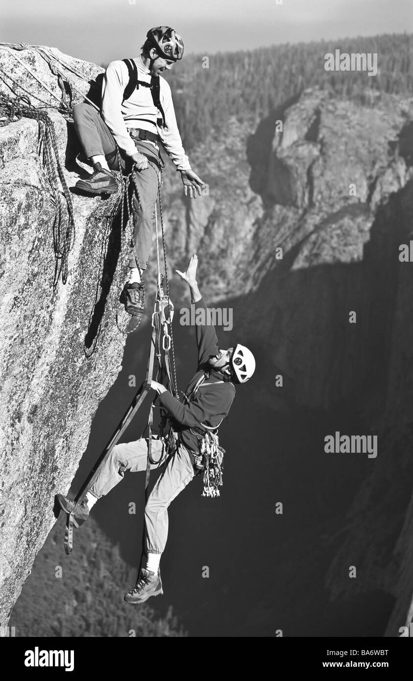 Team of rock climbers reaching the summit Stock Photo Alamy