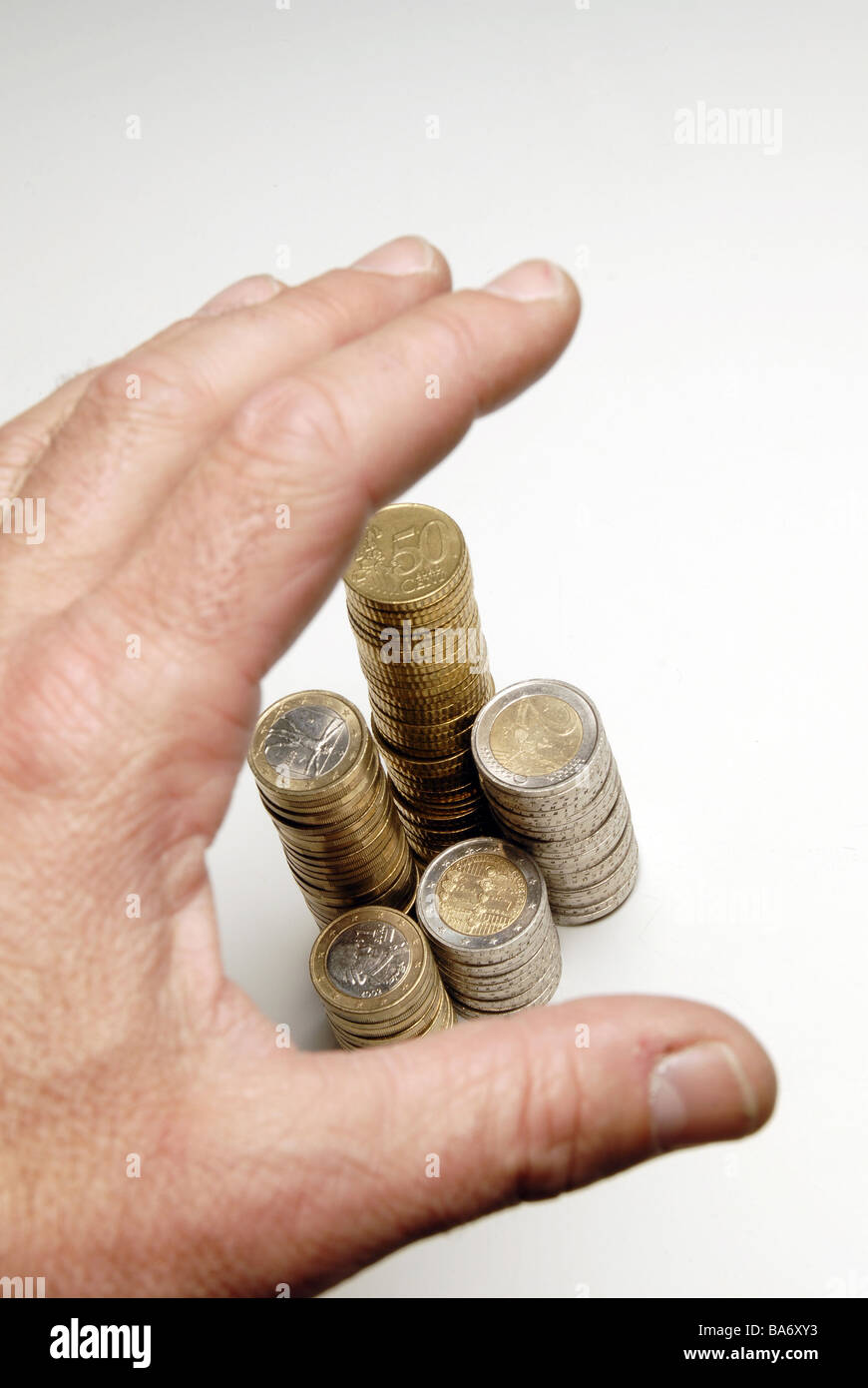 Euro-coins stacked men's-hand detail people man hand money Euro coins value differently counted counts sorts finances economy Stock Photo