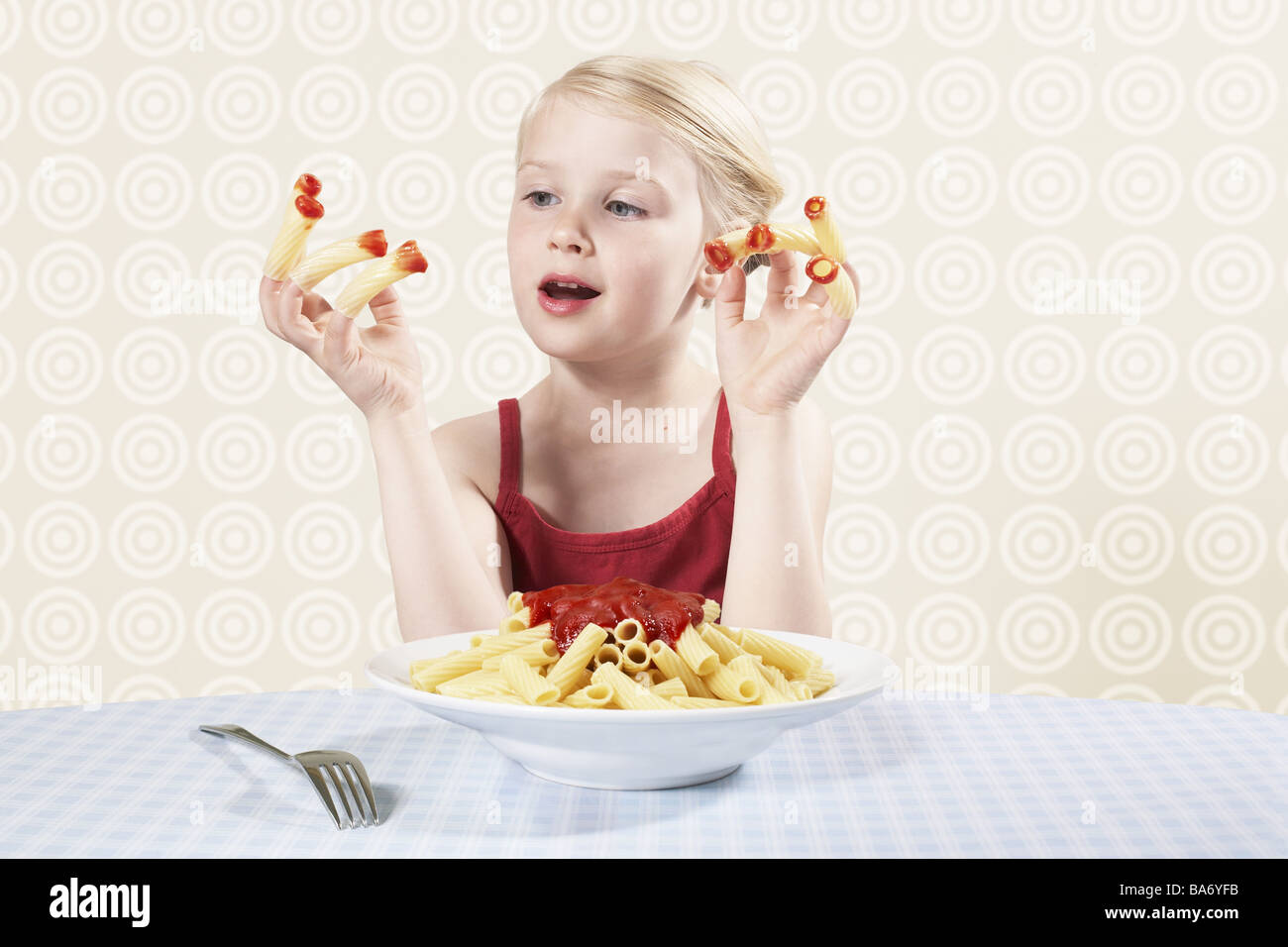 Girls fingers noodles 'Rigatoni' given up tops ketchup semi-portrait dunked people child child-portrait childhood 5-6 years Stock Photo