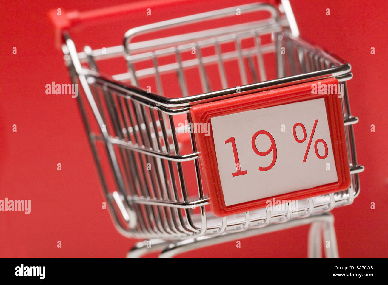Miniature-shopping carts 19 percent MWST shopping carts broached symbol consumption shopping taxes tax office value added Stock Photo