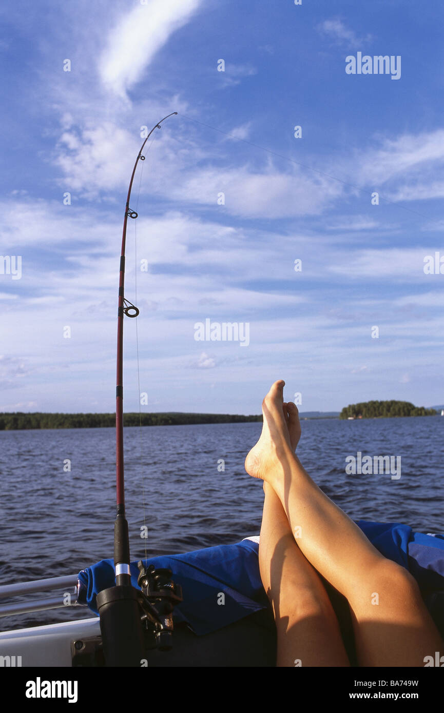 Boat woman legs puts up fishing rod detail people women-legs enjoys  recuperation relaxation relaxen leisure time hobby vacation Stock Photo -  Alamy
