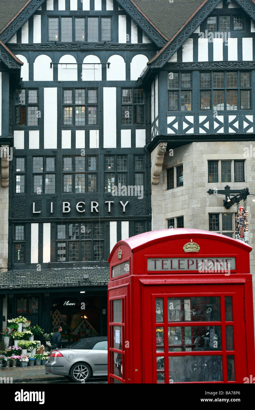 Red Telephone box in front of Liberty department store mock tudor entrance, Great Marlborough Street, London, England, UK. Stock Photo