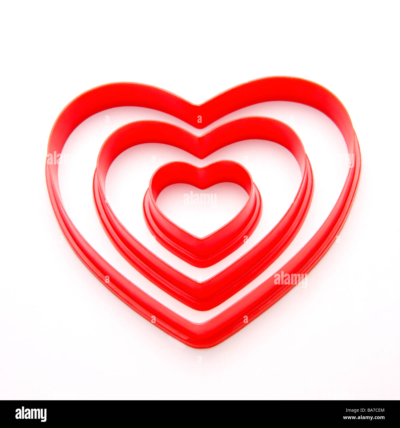 Three different sized heart shaped objects Stock Photo