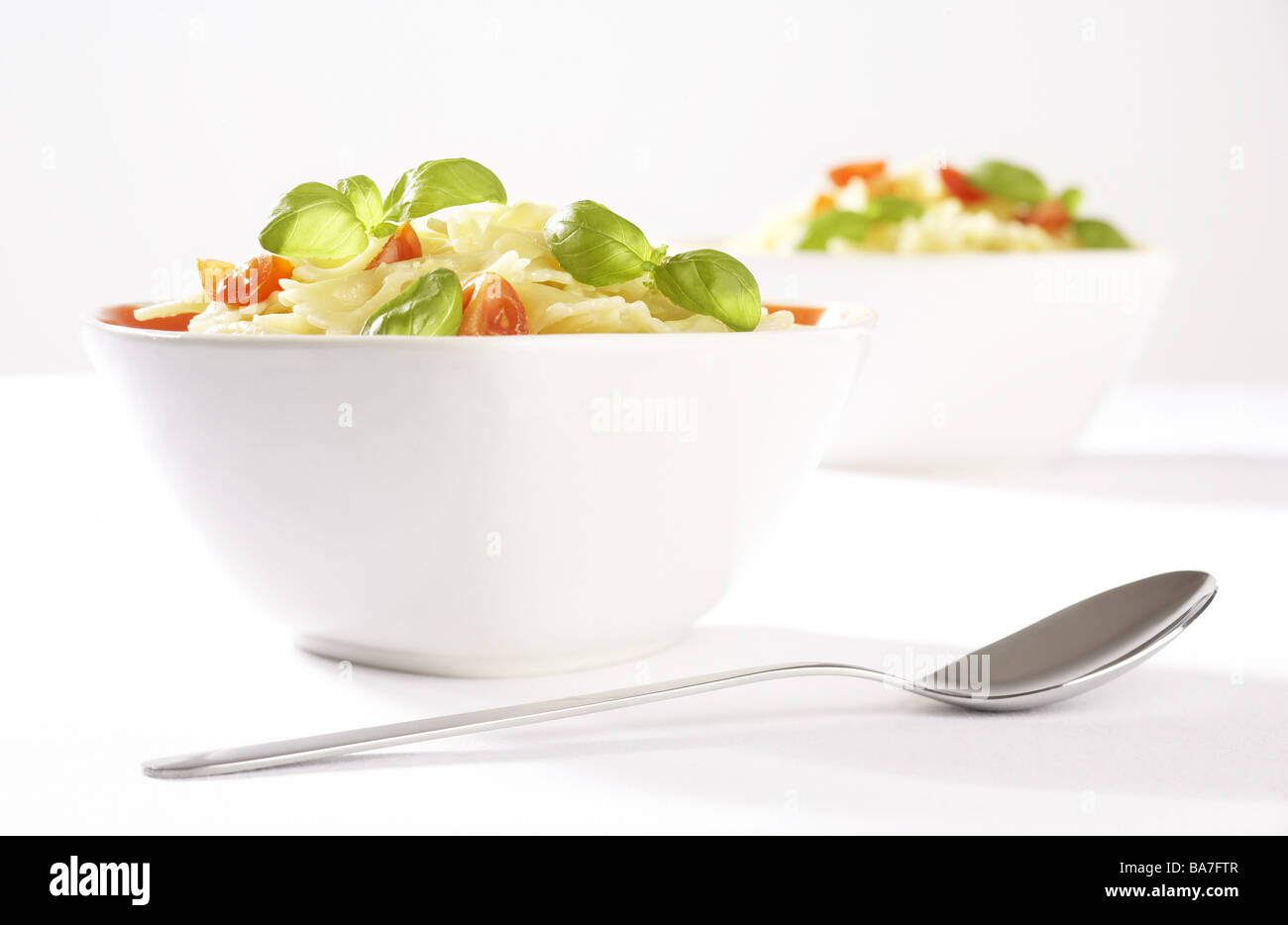 Peels two noodlecourt spoon dishes bowls pasta noodles tomatoes basil