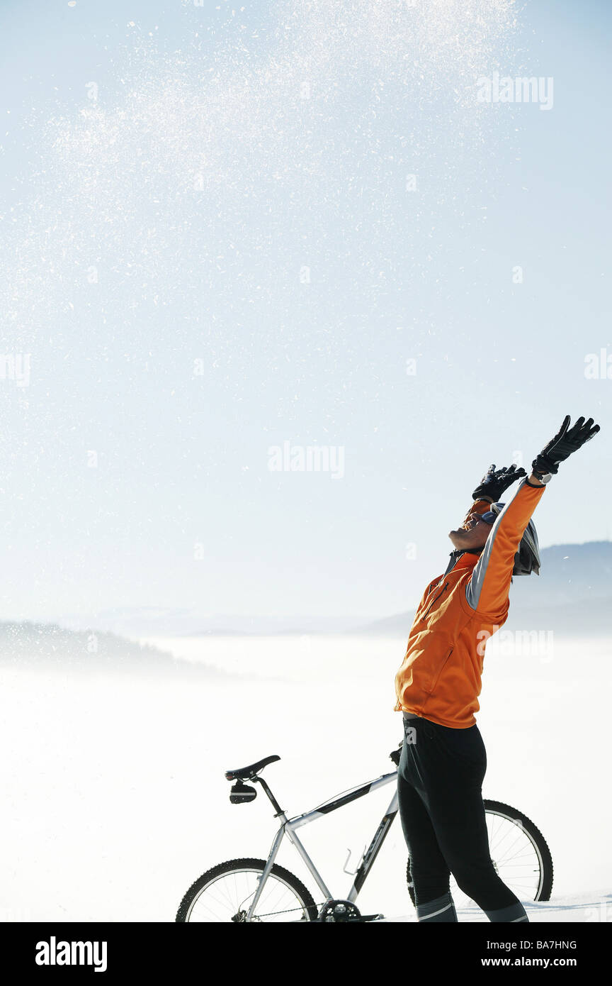 Mountain biker throwing snow up in the air, Styria, Austria Stock Photo