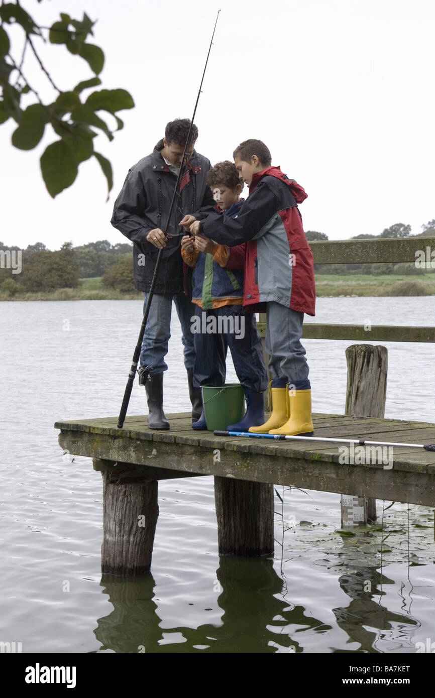 Sea bridge father sons fishing rod-equipment cheerfully autumn