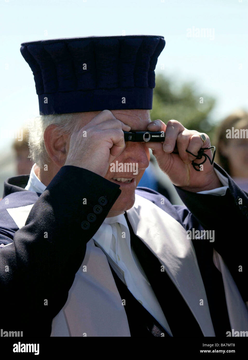 AN ADVOCATE IN TRADITIONAL ROBES TAKING A PHOTOGRAPH IN THE CHANNEL ...