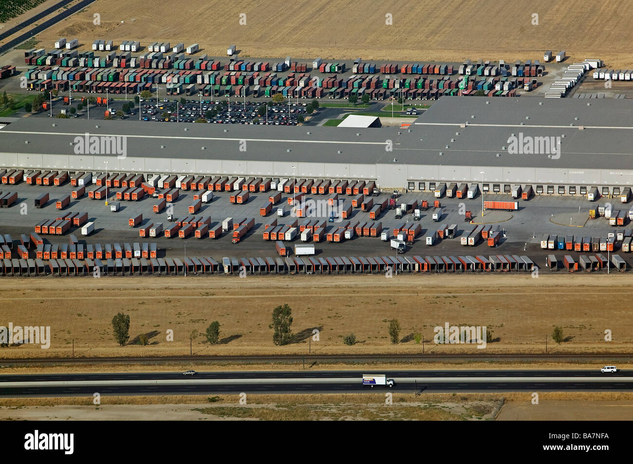 aerial view above warehouse trucks containers highway 99 Central Valley