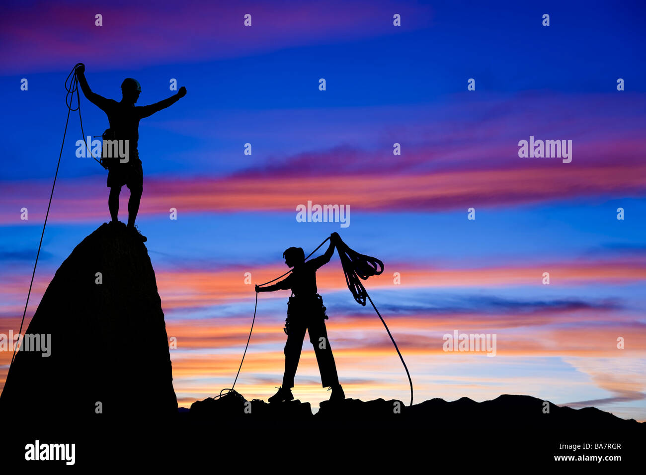 Team of rock climbers on the summit. Stock Photo