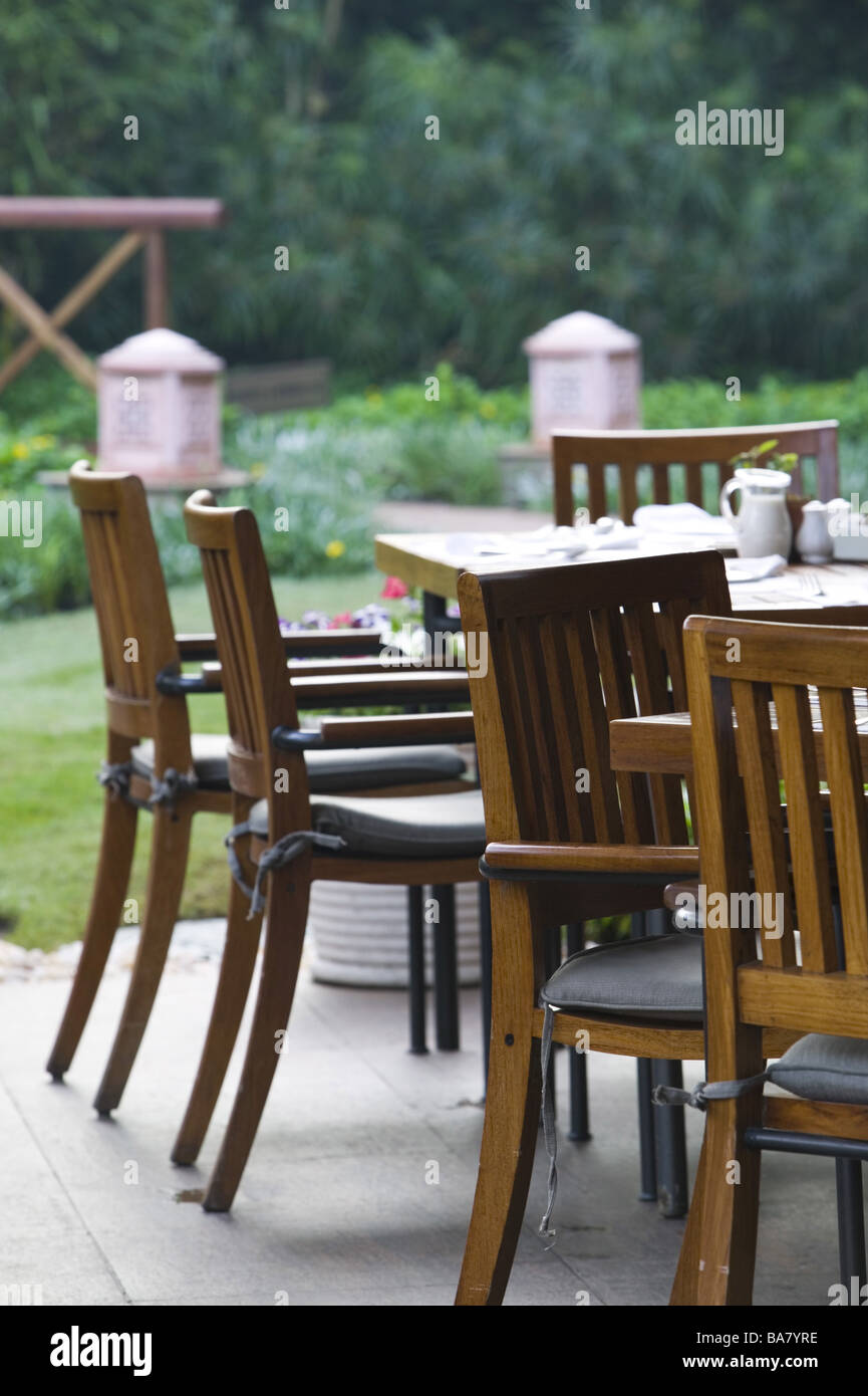 Terrace cafe-tables chairs detail cafe pub garden garden-terrace gastronomy human-empty outside tables wood-chairs Stock Photo