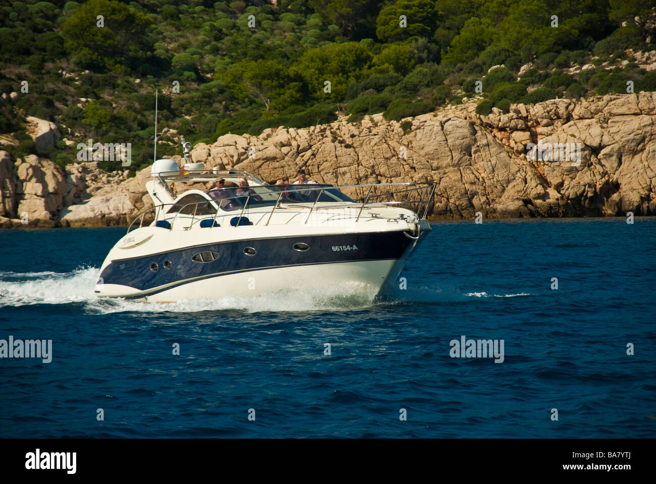 Powerboat in front of cliff La Dragonera Majorca Baleares Spain | Yacht vor einer Klippe La Dragonera Mallorca Balearen Spanien Stock Photo