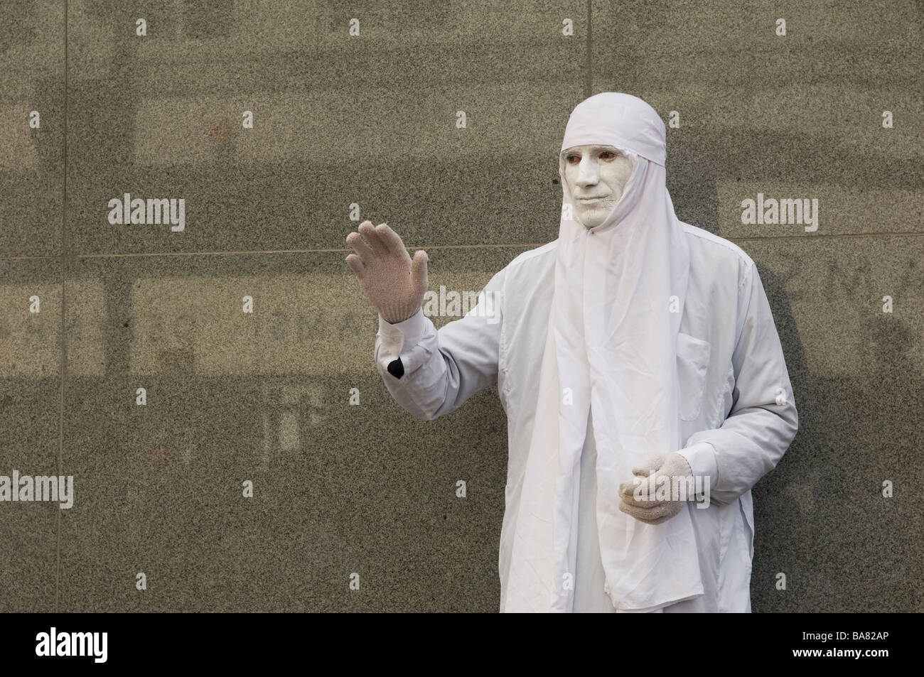 Mime artist with white face paint performing in Manchester city centre UK Stock Photo