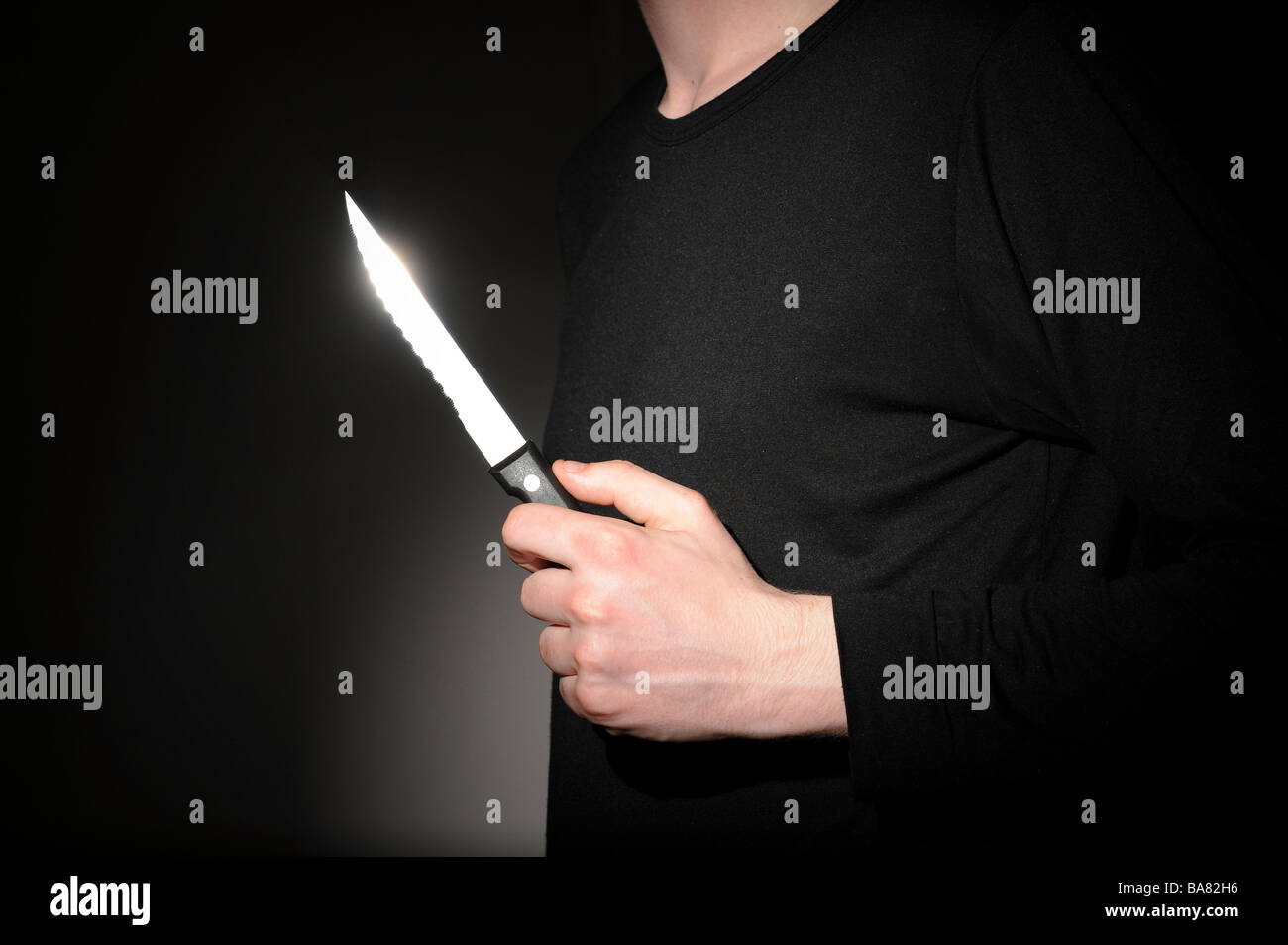 Man holding an offensive weapon Stock Photo
