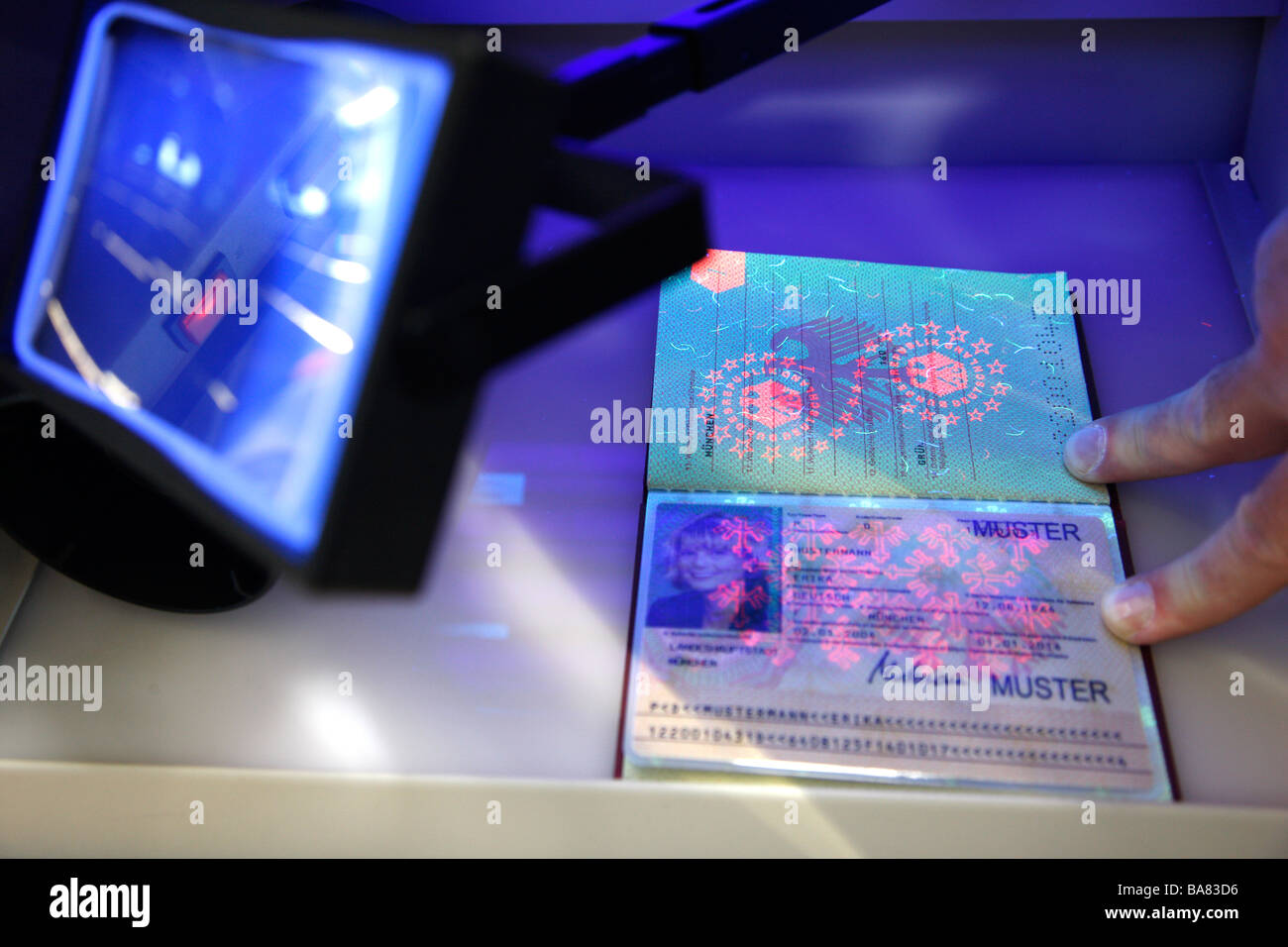Control of documents with UV light by German police. Stock Photo