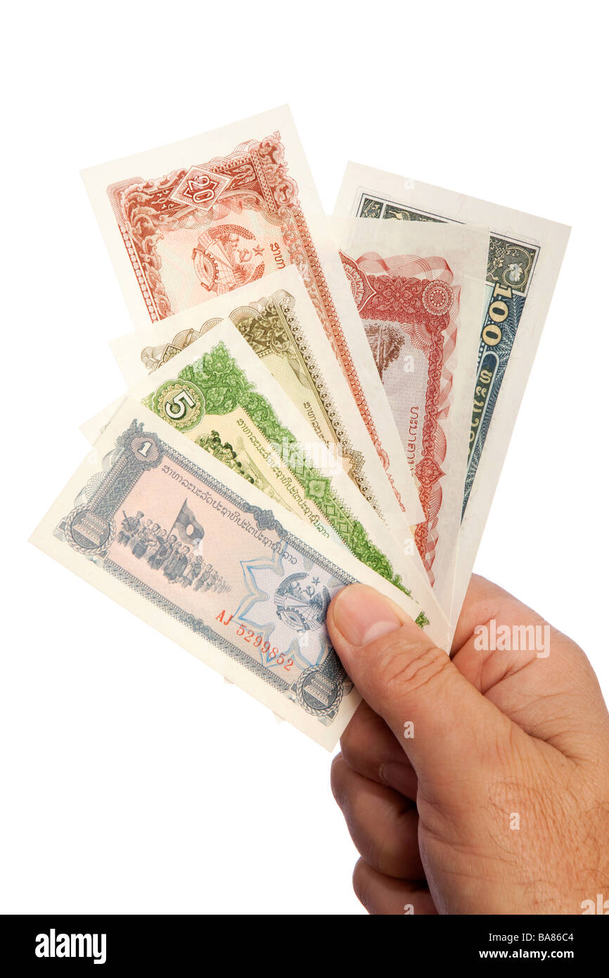 Money male hand holding handful of old low denomination Lao currency Stock Photo