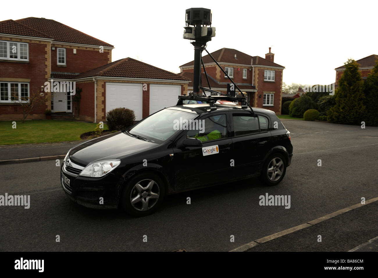 Google streetview car films in a residential street, Stock Photo