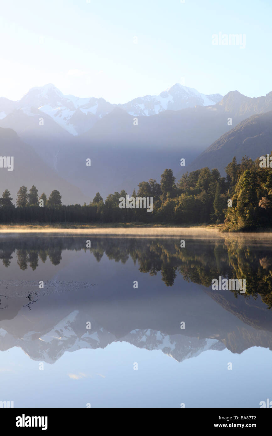 Southern Alps reflected in the  still water of Lake Matheson,Franz Josef,West Coast,South Island,New Zealand,Oceania Stock Photo