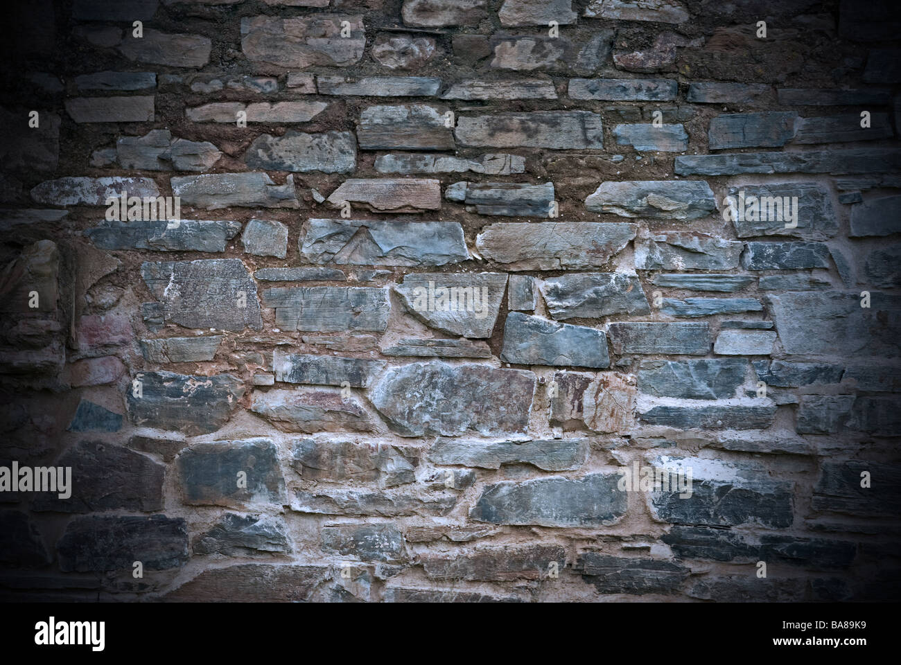 an old dirty and grungy stone wall background Stock Photo - Alamy