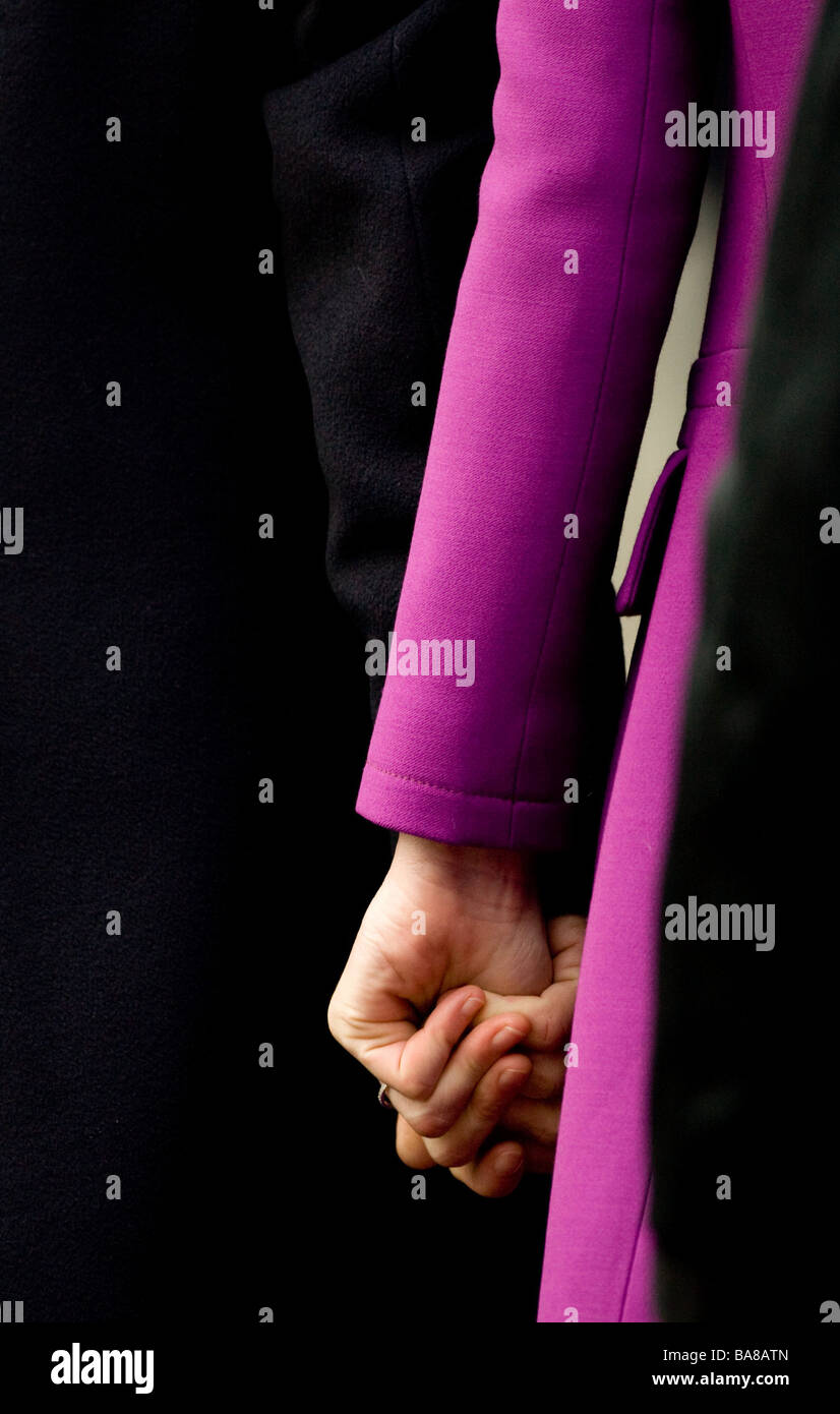 French President Nicolas Sarkozy holds hands with his wife Madame Carla Bruni Sarkozy during a visit to Britain Stock Photo