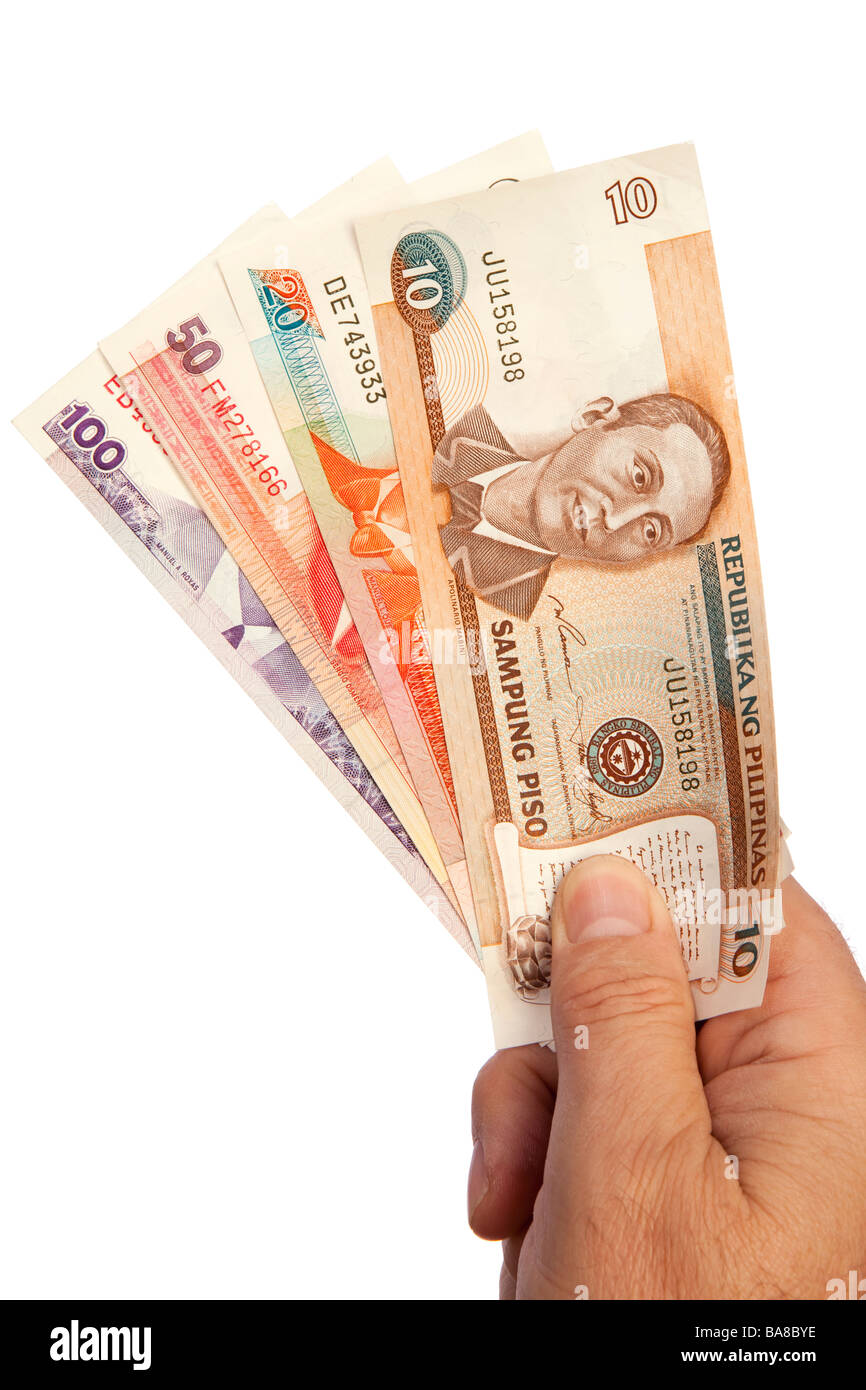 Money male hand holding handful of Philippines currency Stock Photo