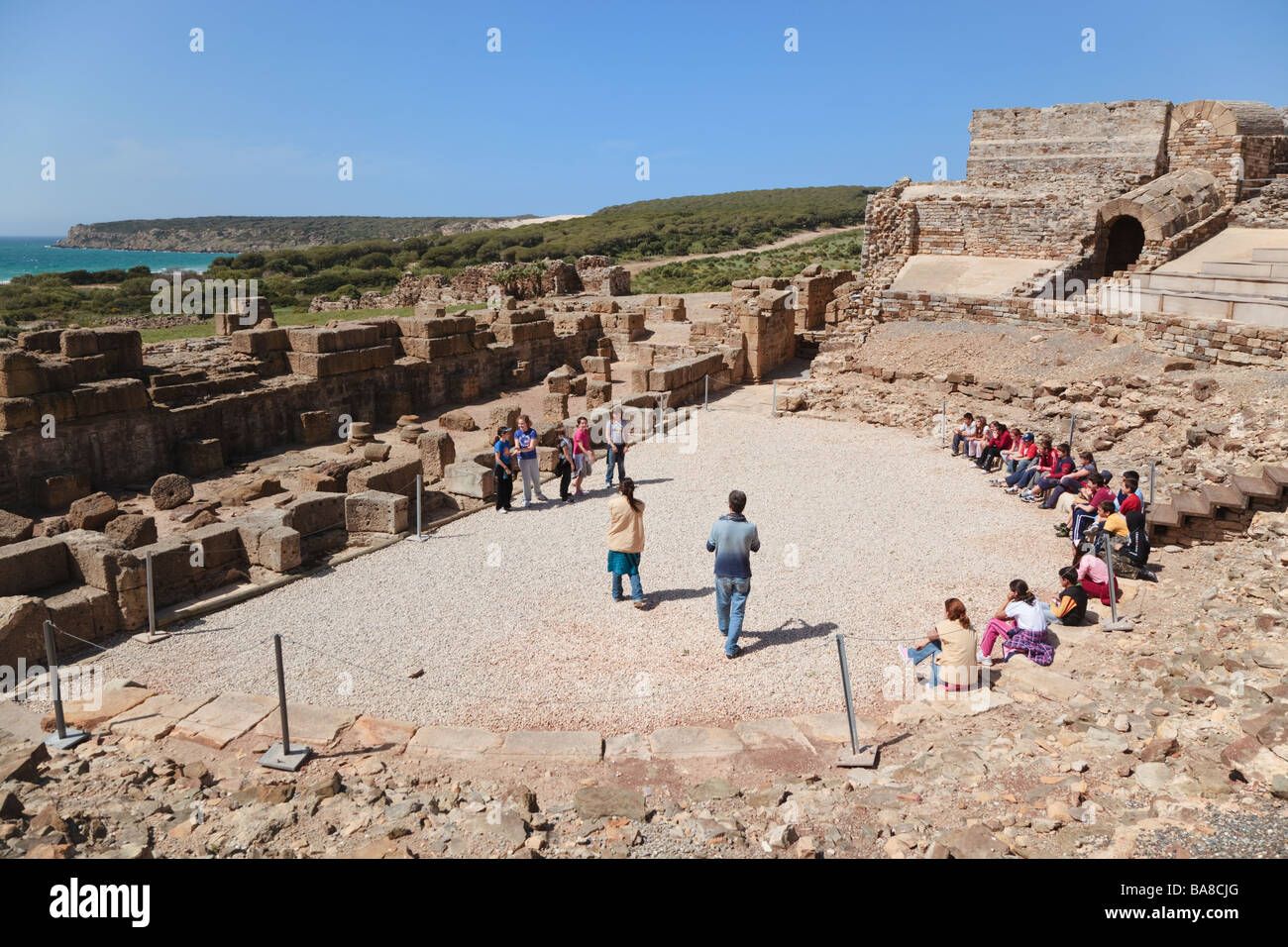 Roman ruins of Baelo Claudia at Bolonia Cadiz Province Spain Group of school children visiting the theatre Stock Photo