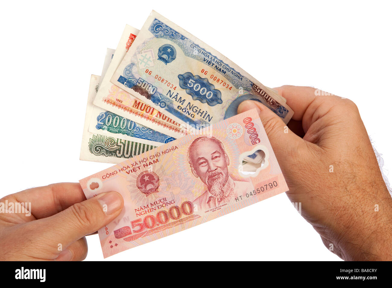 Money male hands holding handful of Vietnamese currency Stock Photo