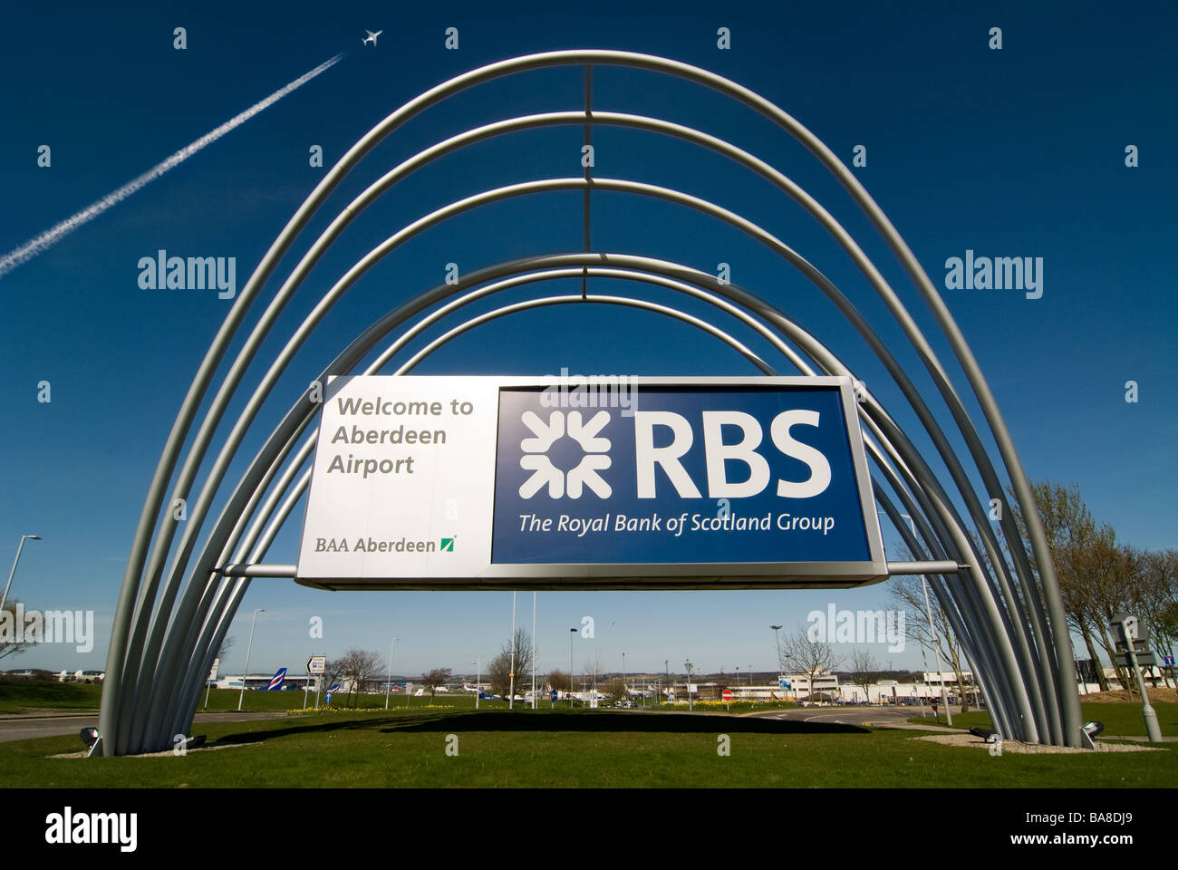 photograph of aberdeen airport rbs signage with aircraft overhead Stock