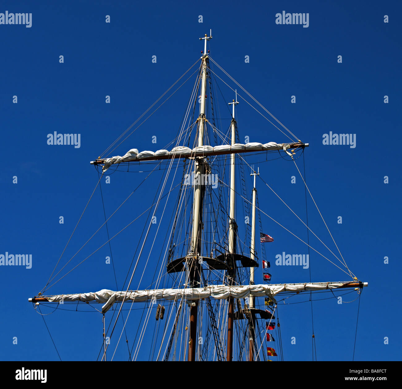 tallship tallships three masts with furled sails against blue sky
