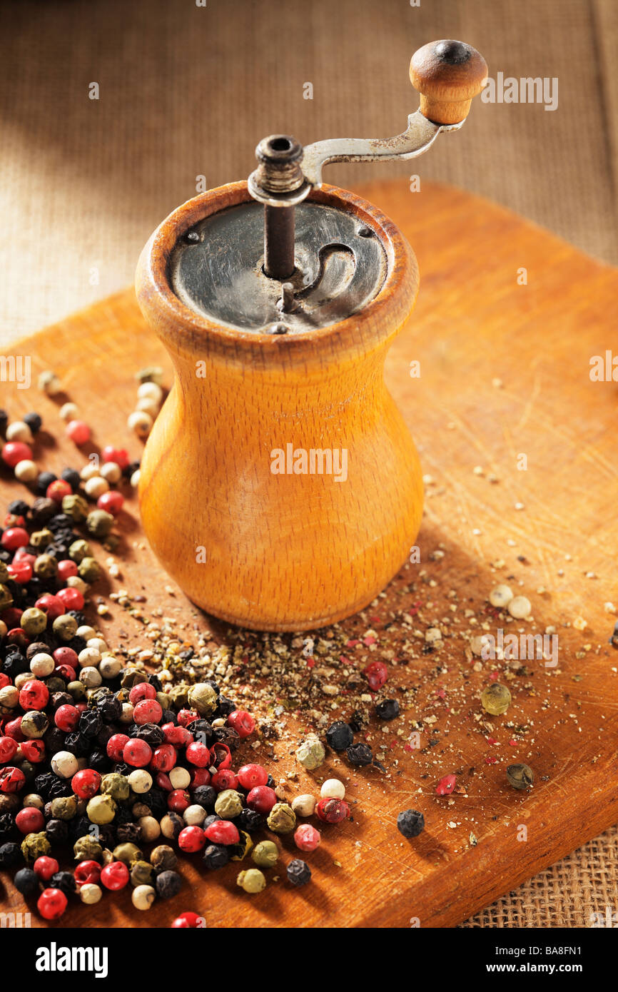 An old pepper grinder and mixed dried peppers Stock Photo - Alamy