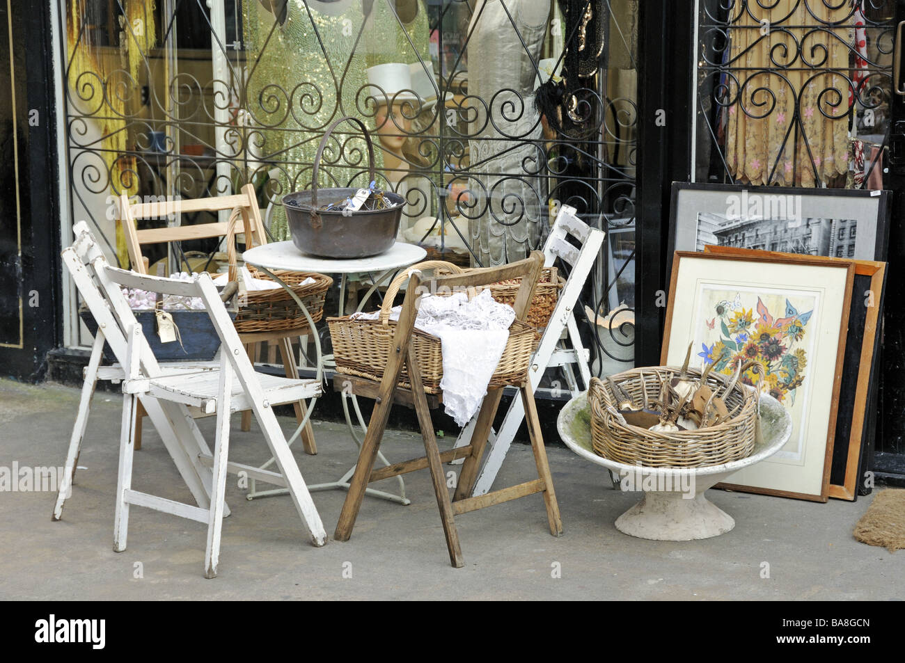 Old table and chairs outside antique shop Camden Passage London England
