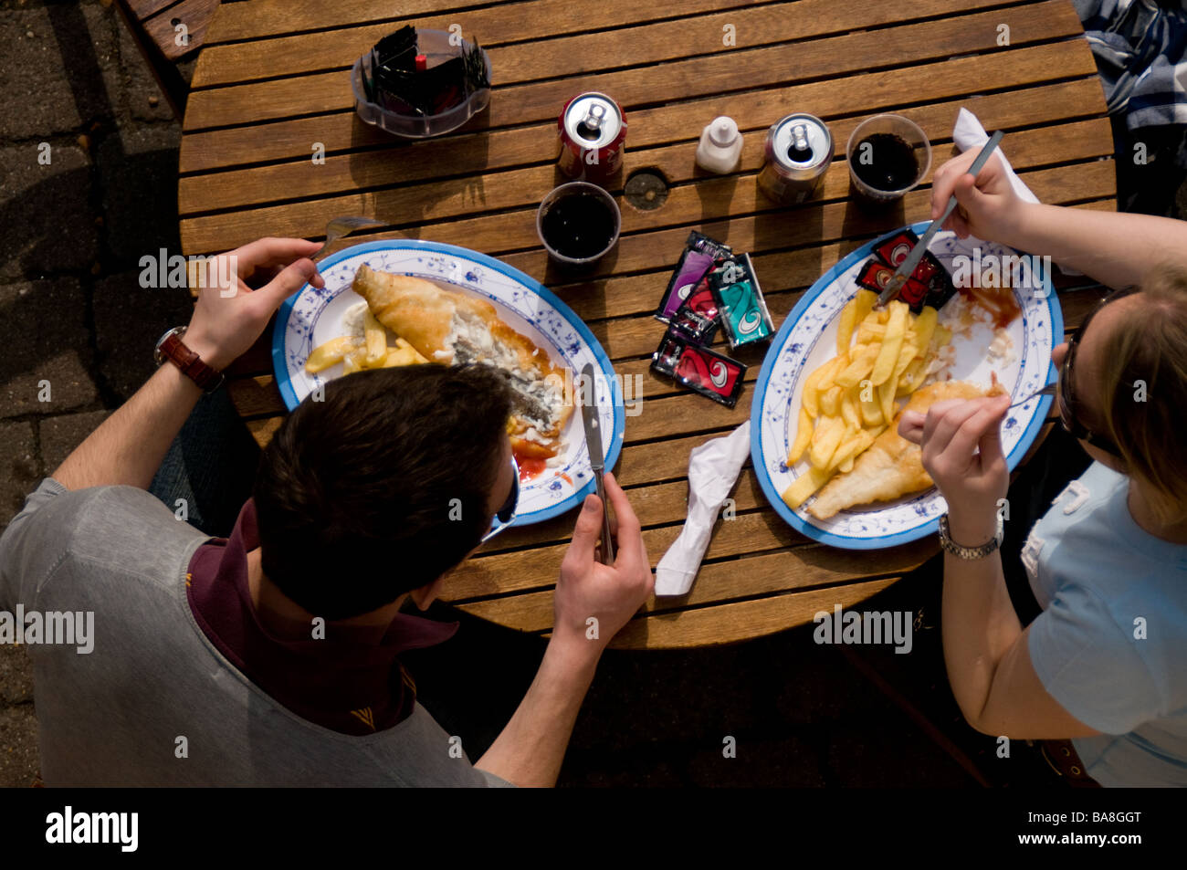 People Eating Fish and Chips Stock Photo