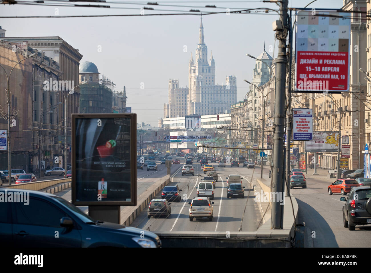 Moscow traffic with one of the seven sisters Stalin era Kurdinskaya square buildings in the background, Moscow, Russia. Stock Photo