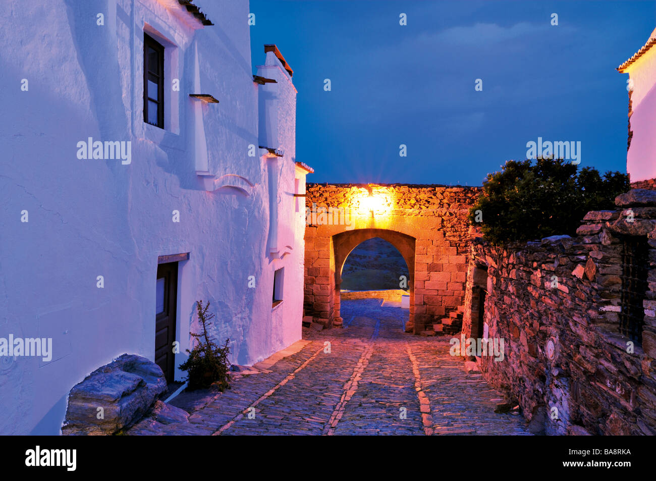 Medieval alley Travessa D. Dinis and wall entrance Porta de Alcoba in the historical village Monsaraz Stock Photo
