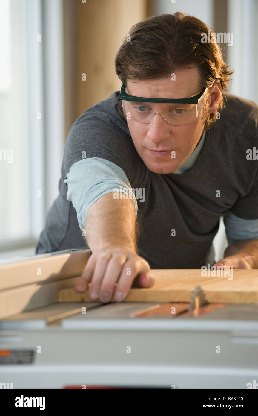 Construction worker cutting board Stock Photo