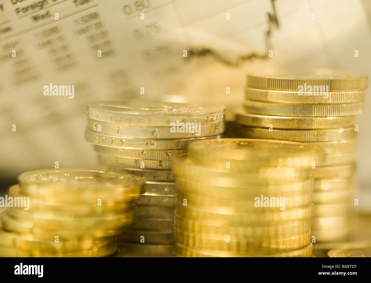 Stacks of euro coins and exchange rates Stock Photo
