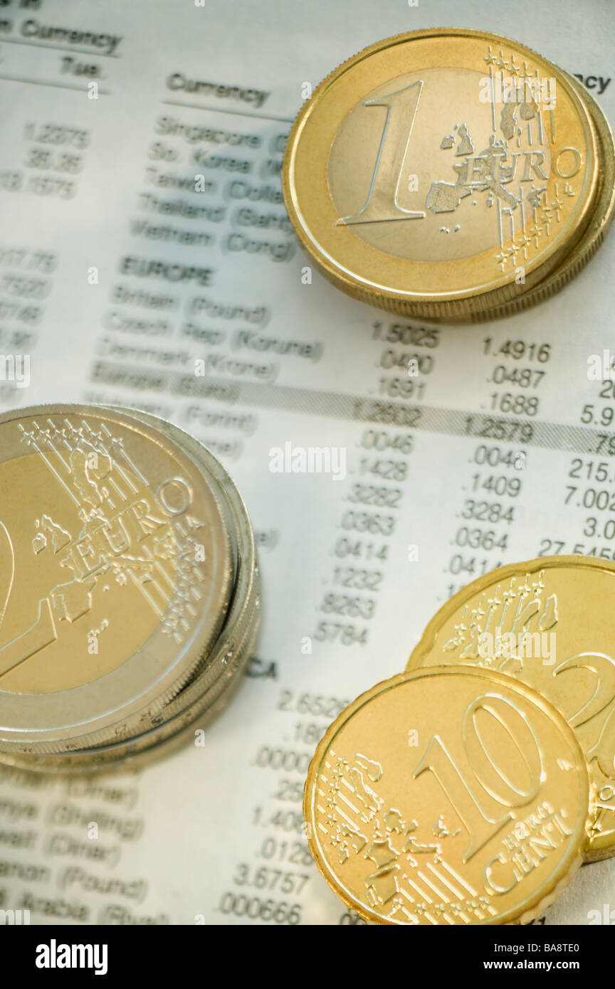 Stacks of euro coins and exchange rates Stock Photo