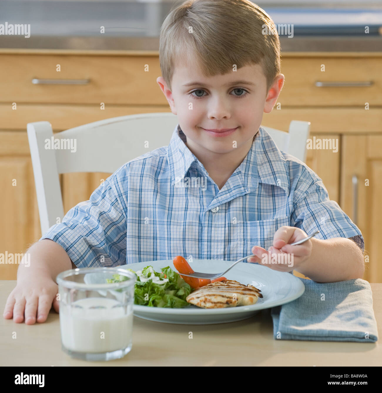 Boy eating dinner Stock Photo