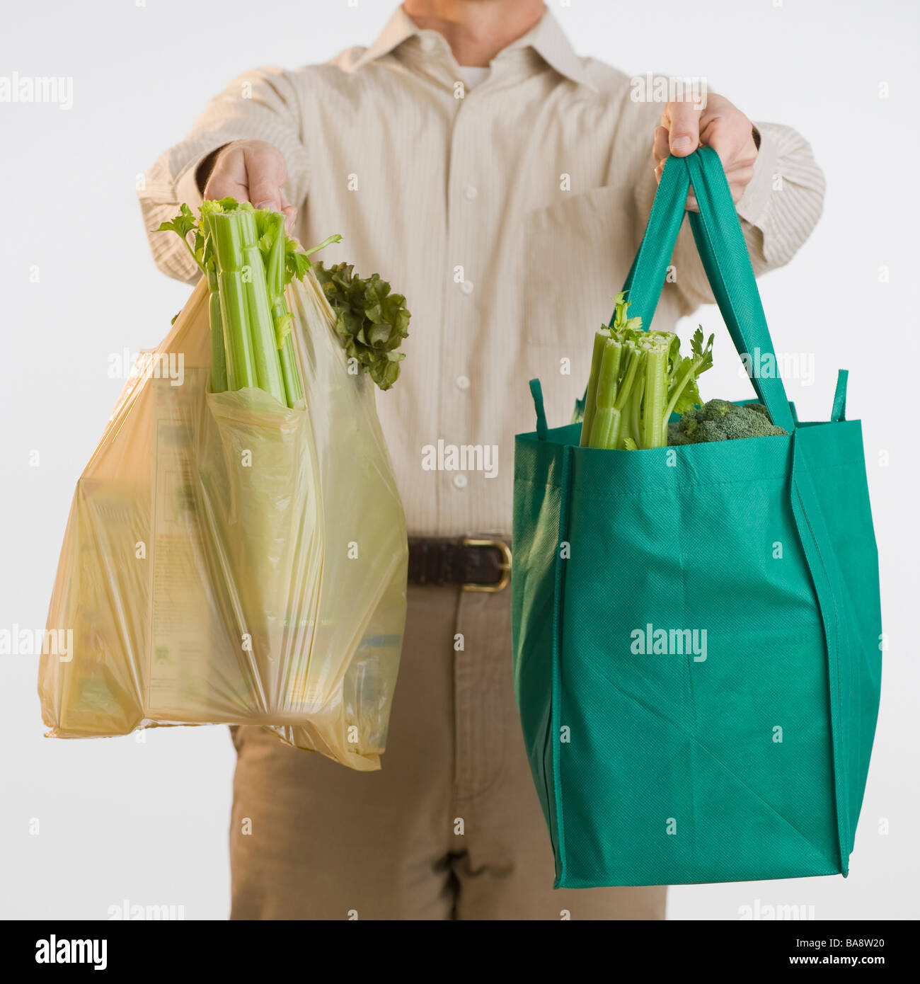 Man holding reusable grocery bags Stock Photo