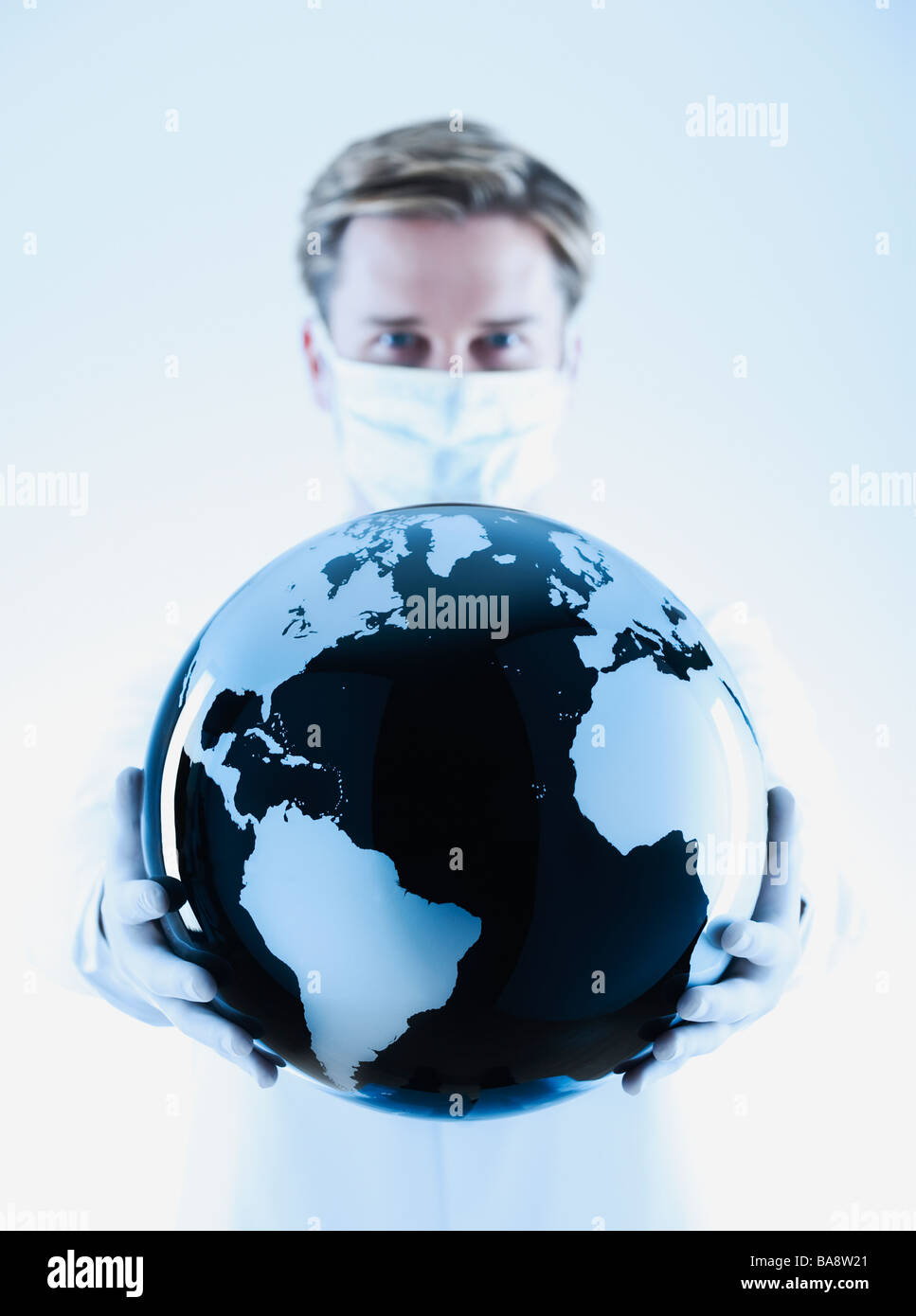 Scientist holding black and white globe Stock Photo