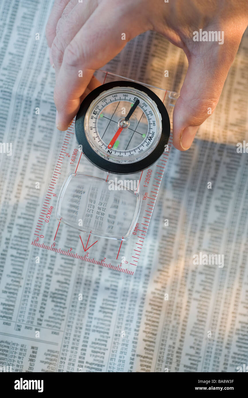 Man holding compass over stock pages Stock Photo