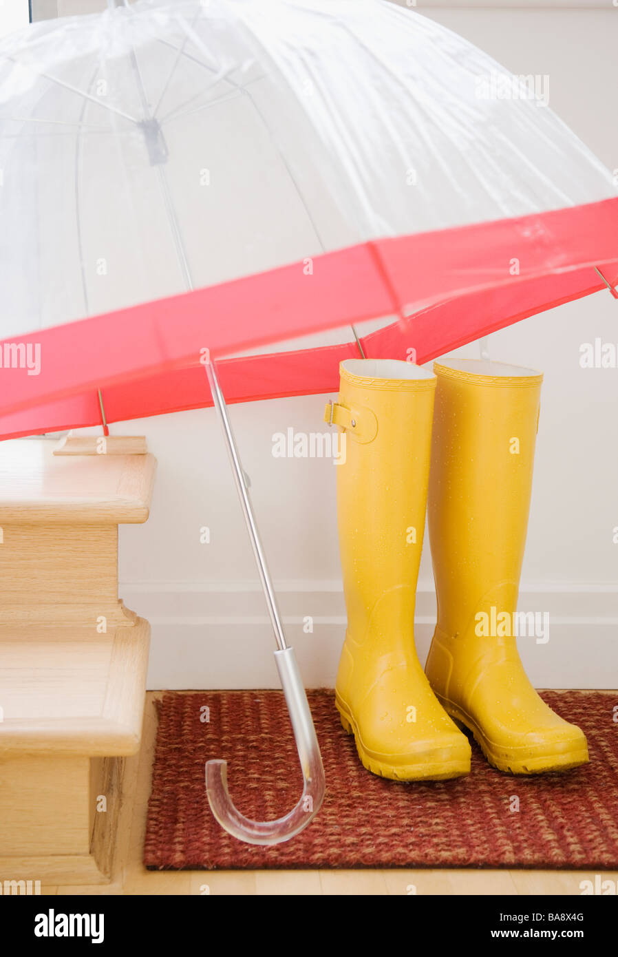 Rain boots and umbrella drying indoors Stock Photo Alamy