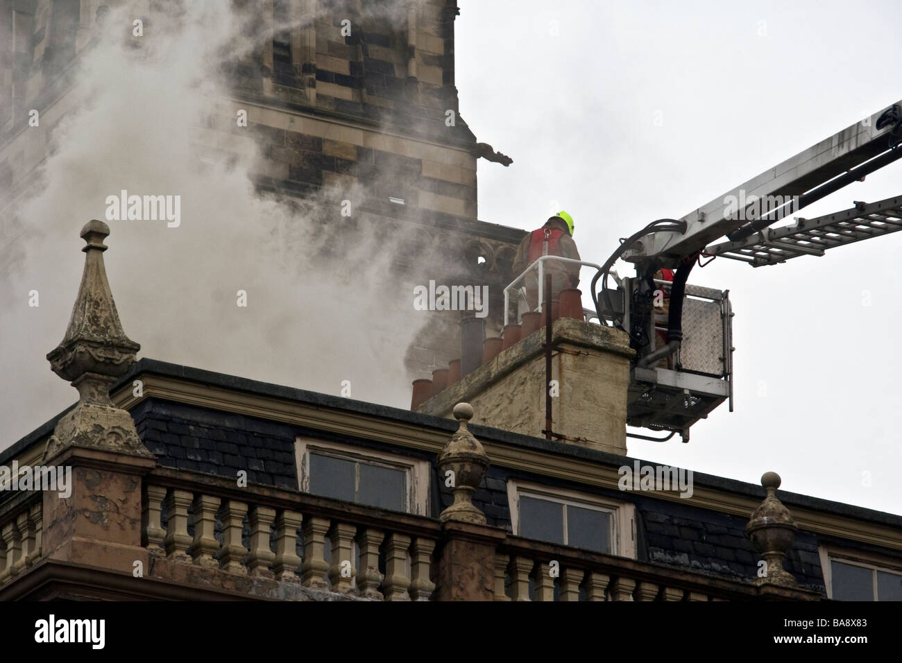 Firemen extinguishing smoke billowing out from the rooftops of local Braithwaites coffee shop in Dundee city centre,UK Stock Photo