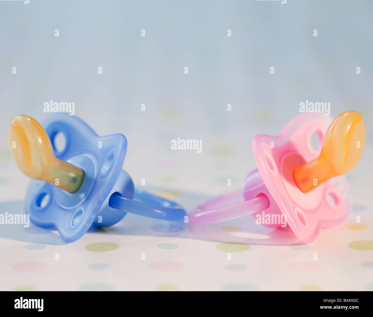 Pink and blue baby pacifiers Stock Photo