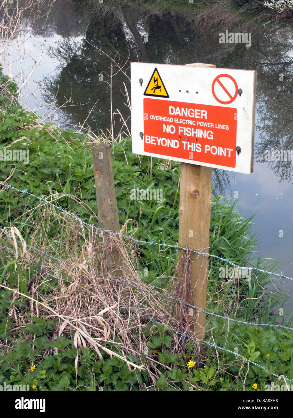 UK.Somerset. Signs for overhead power lines banning fishing and angling on the Frome River.Photo. Julio Etchart Stock Photo
