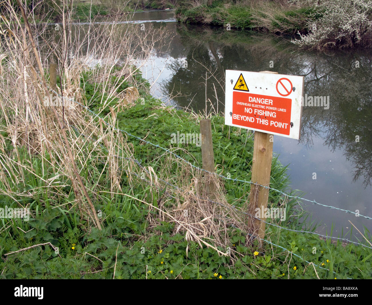 UK.Somerset. Signs for overhead power lines banning fishing and angling on the Frome River.Photo. Julio Etchart Stock Photo
